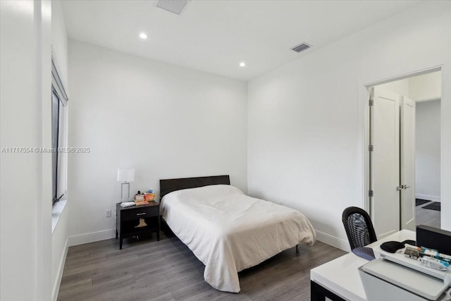 bedroom with dark hardwood / wood-style floors