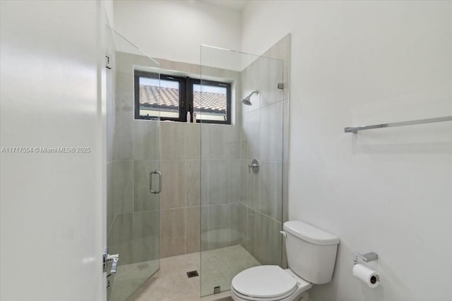 bathroom featuring an enclosed shower and toilet