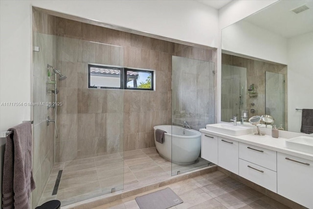 bathroom featuring tile patterned floors, vanity, and plus walk in shower