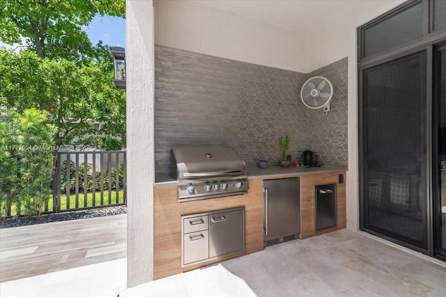 view of patio / terrace with an outdoor kitchen and a grill