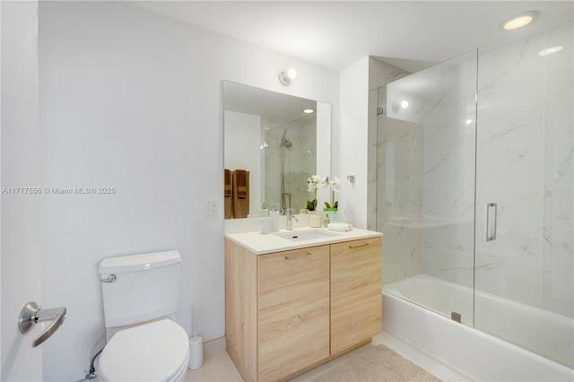 full bathroom with combined bath / shower with glass door, vanity, and toilet