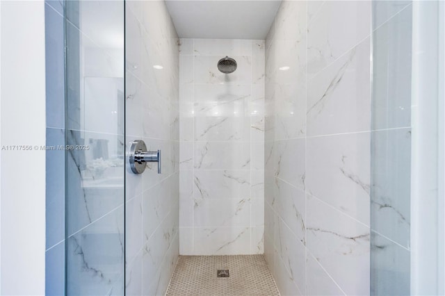 bathroom with a tile shower