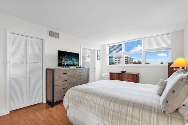 bedroom featuring a closet and light hardwood / wood-style flooring