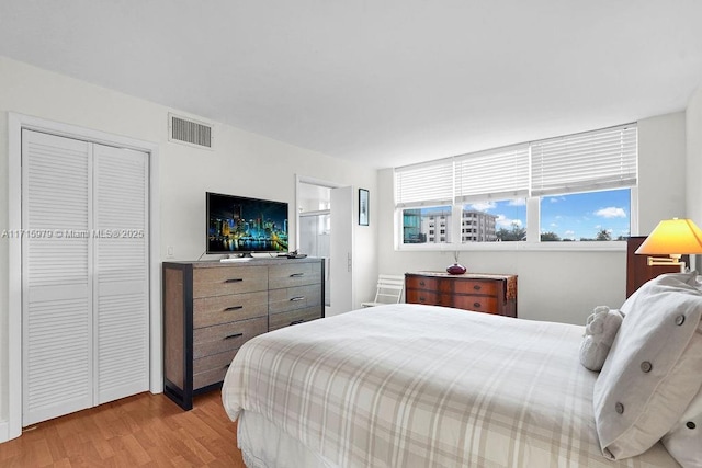 bedroom featuring light wood-type flooring and a closet