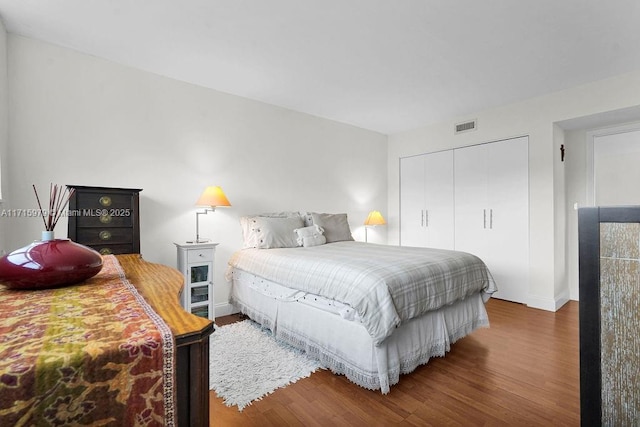 bedroom featuring wood-type flooring and a closet