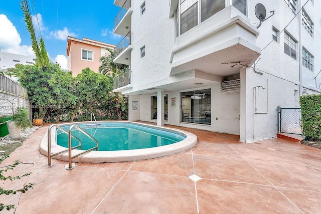 view of swimming pool with a patio