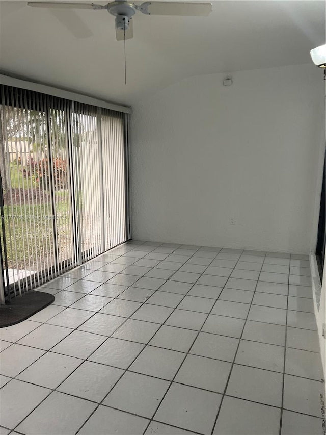 empty room with ceiling fan and light tile patterned floors