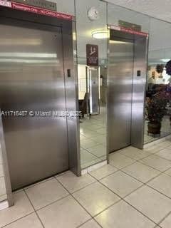 kitchen with elevator and light tile patterned floors