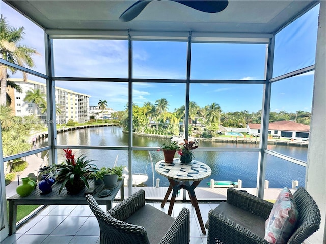 sunroom featuring a water view