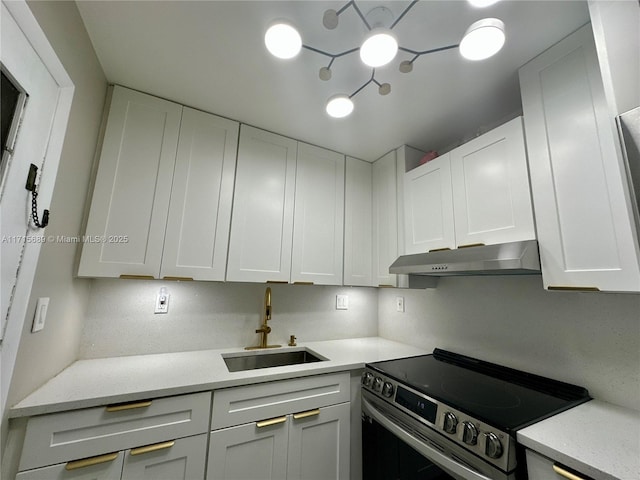 kitchen featuring white cabinetry, sink, and stainless steel range with electric stovetop