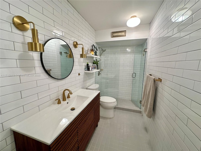 bathroom with walk in shower, vanity, toilet, and tile walls