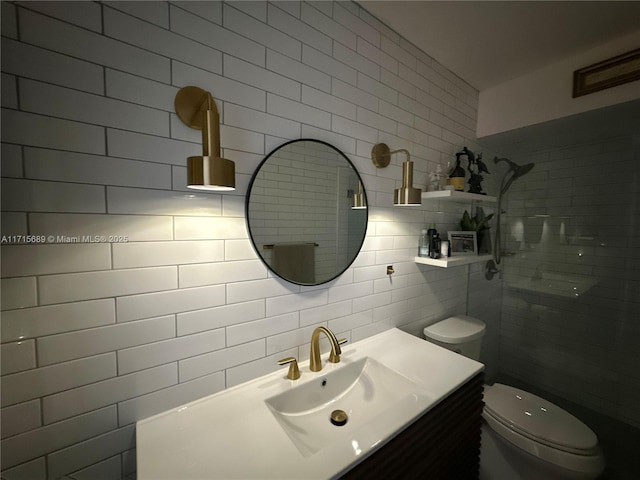 bathroom with vanity, toilet, backsplash, and tile walls