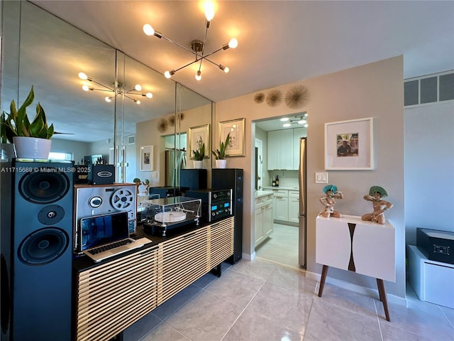 kitchen featuring light tile patterned flooring and an inviting chandelier