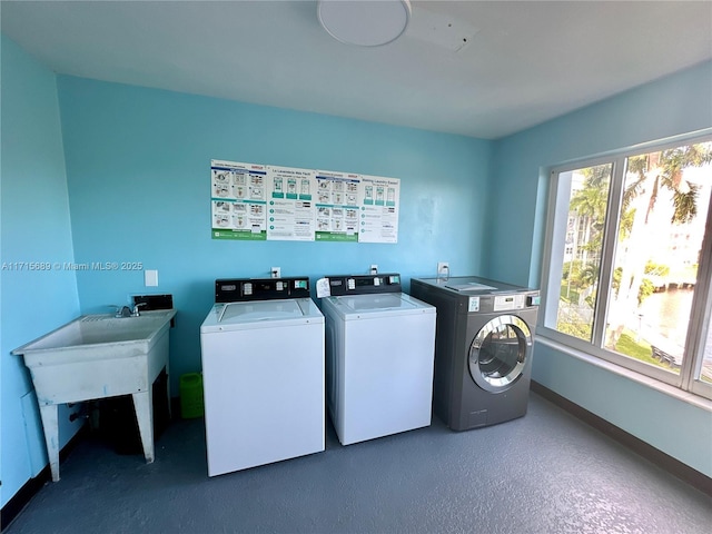 clothes washing area featuring separate washer and dryer