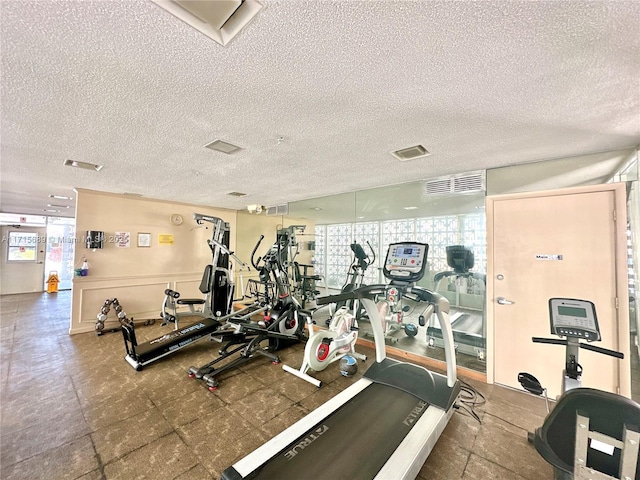 exercise room featuring a textured ceiling