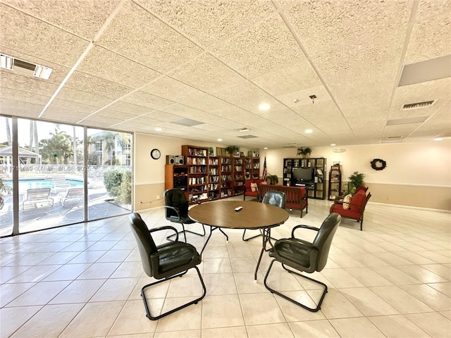 tiled dining room featuring floor to ceiling windows