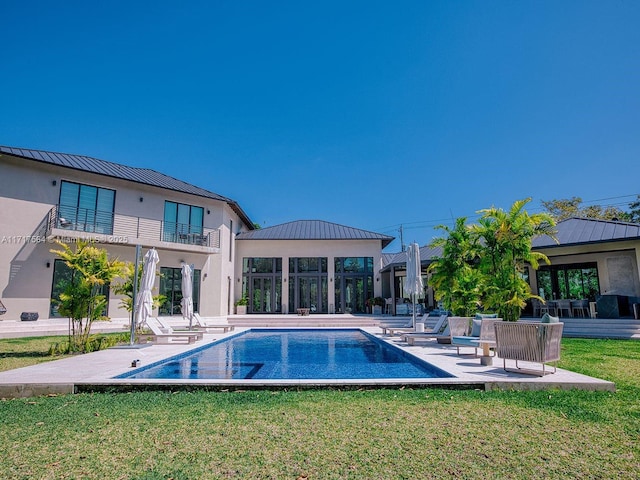 view of pool featuring a yard and a patio area