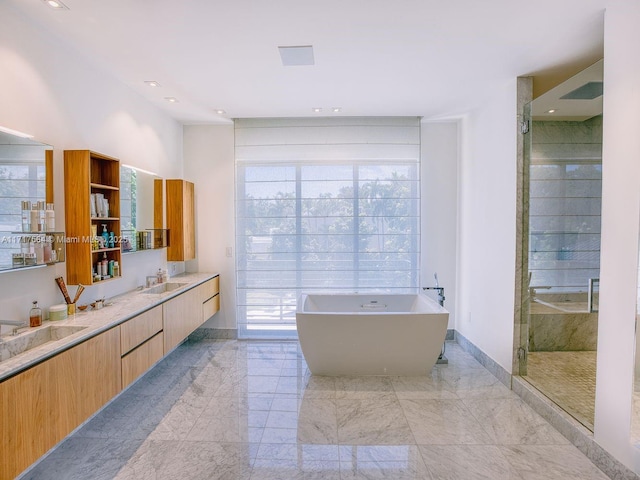 bathroom featuring vanity and shower with separate bathtub