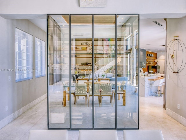 interior space featuring a wealth of natural light and light tile patterned flooring