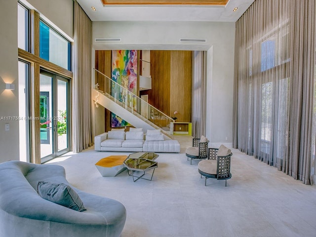 living room with a healthy amount of sunlight and a towering ceiling