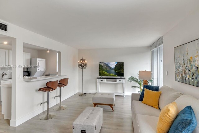 living room with light wood-type flooring and sink