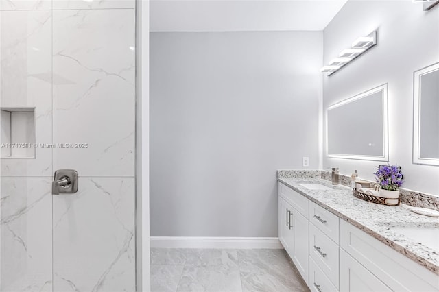 bathroom with a shower and vanity