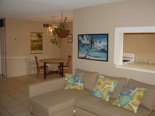 tiled living room featuring a chandelier