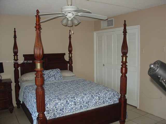 bedroom with light tile patterned floors, a closet, and ceiling fan