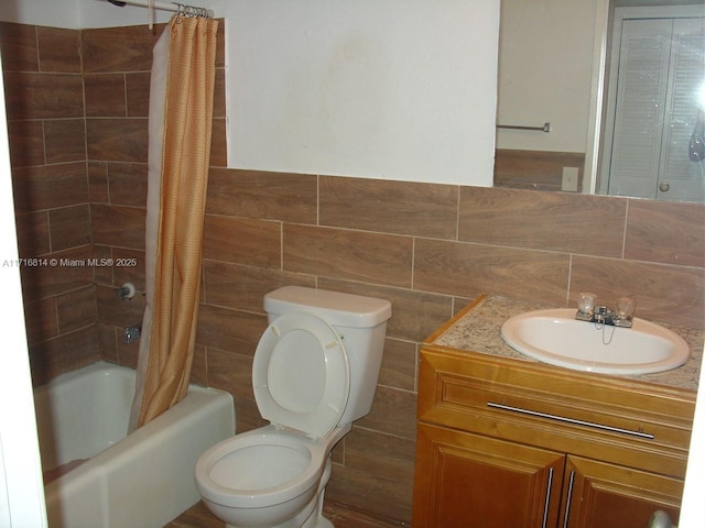 full bathroom featuring tasteful backsplash, vanity, shower / bathtub combination with curtain, tile walls, and toilet