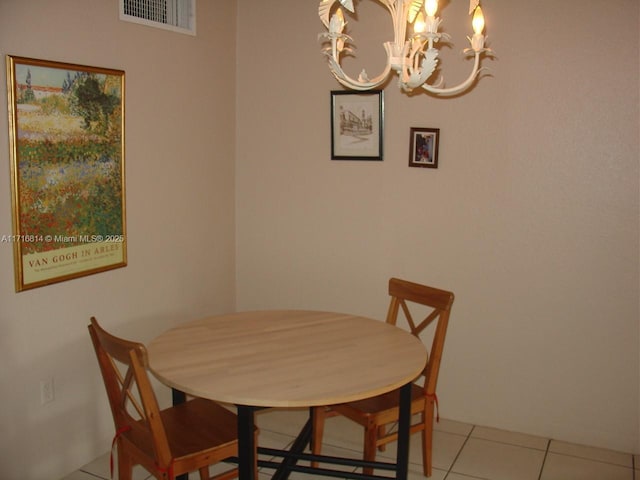 dining room featuring light tile patterned floors and an inviting chandelier