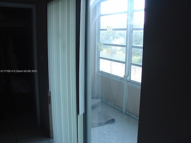 corridor featuring light tile patterned floors