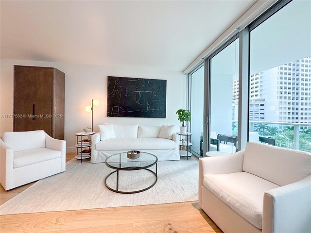 living room featuring track lighting, electric panel, and light hardwood / wood-style flooring