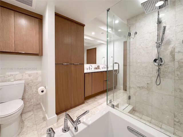 full bathroom featuring shower with separate bathtub, vanity, and toilet