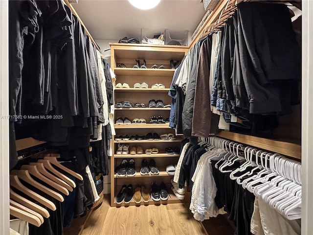 spacious closet featuring hardwood / wood-style floors