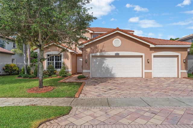 mediterranean / spanish-style house with a garage and a front lawn