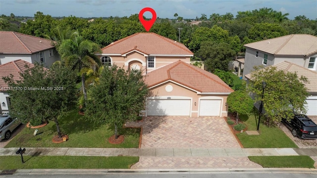 view of front of property featuring a garage and a front lawn