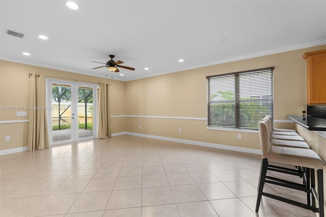 interior space with french doors, ceiling fan, crown molding, and light tile patterned flooring