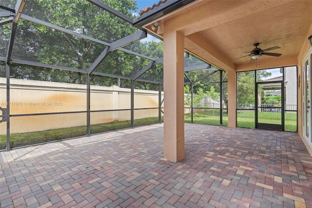 unfurnished sunroom with ceiling fan