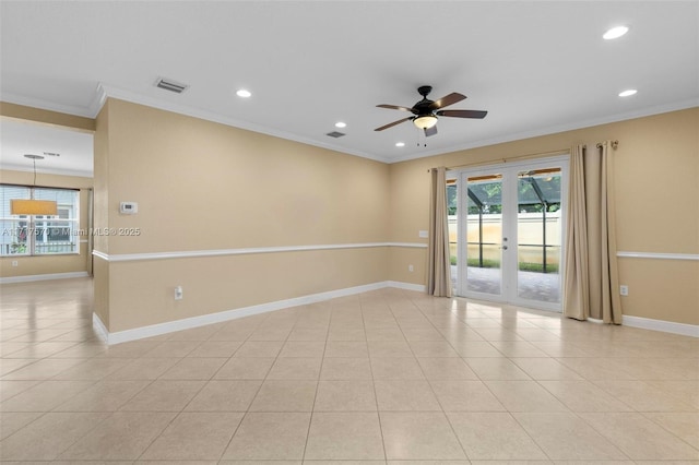 spare room with ceiling fan, ornamental molding, light tile patterned floors, and french doors