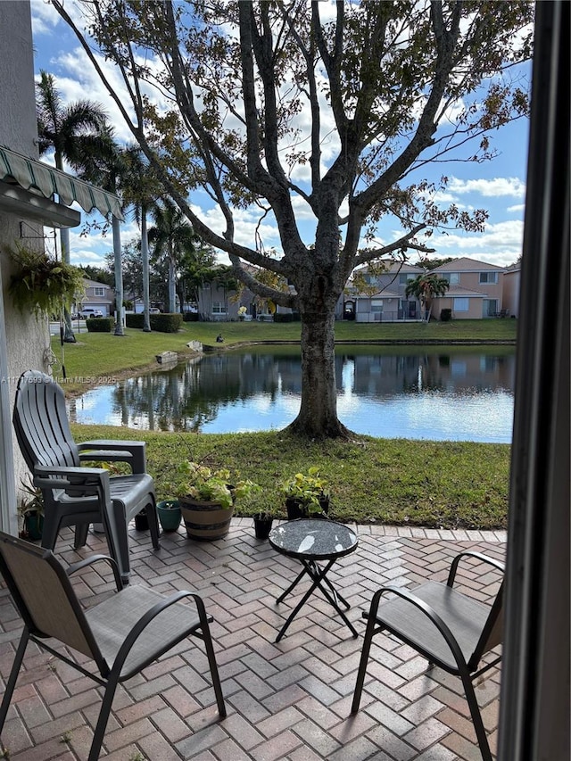 view of patio with a water view