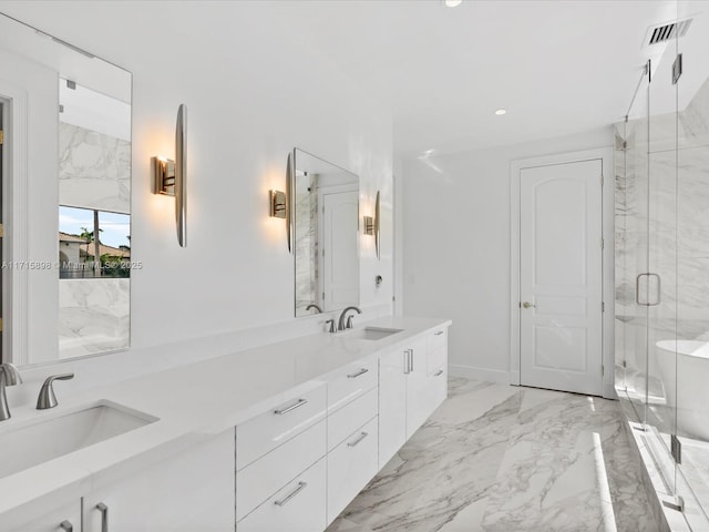 bathroom with vanity and a shower with shower door