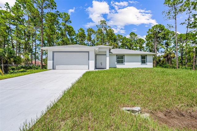 ranch-style home featuring a front yard and a garage