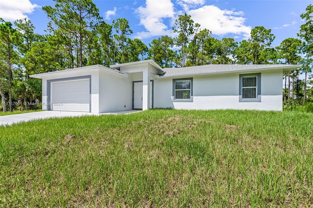 single story home with a garage and a front lawn