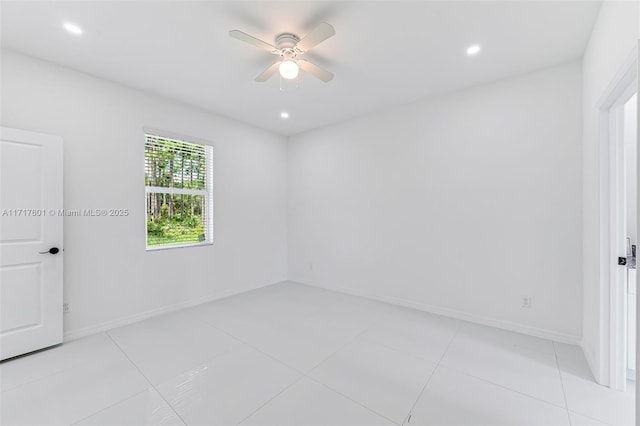 tiled empty room featuring ceiling fan