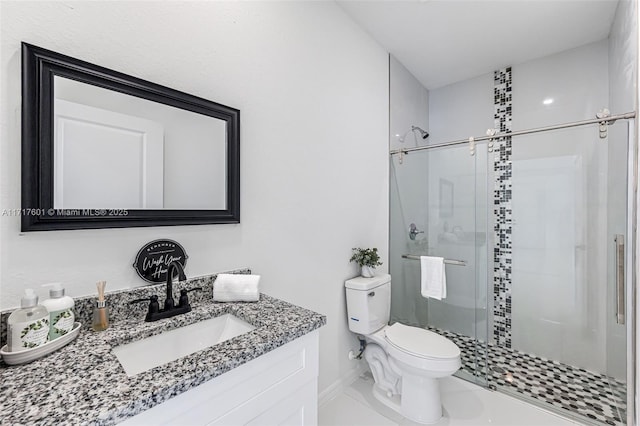 bathroom featuring tile patterned flooring, vanity, toilet, and walk in shower