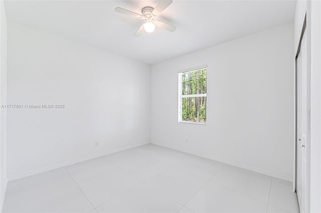 unfurnished room featuring ceiling fan and light tile patterned flooring