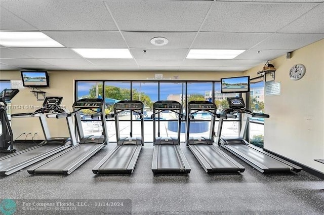 gym with a healthy amount of sunlight and a drop ceiling