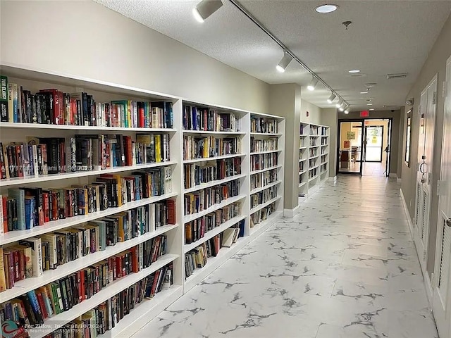 corridor with a textured ceiling