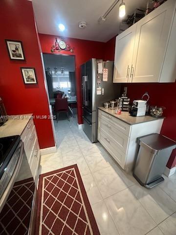 kitchen featuring white cabinetry and appliances with stainless steel finishes