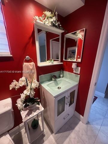 bathroom with vanity and toilet